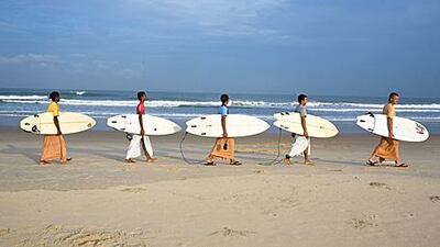 From left: Gaura Gopala, Satyaraj, Kirtan Ananda, Dicky and Daruka Dasa, Krishna devotees at the Kaliya Mardana Krishna Ashram, head out to surf off Mangalore beach in the south Indian state of Karnataka.