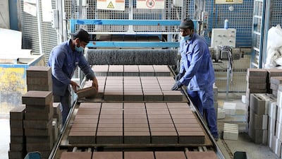 Workers arrange blocks at the Ducon Industries facility. The company already has a workforce of about 170 people, including teams of installers for regular and custom-made paving stones. Pawan Singh / The National