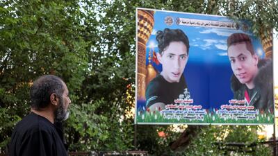 Habib Abbas Alsaadi, father of the two men looking at a photo of his martyred sons in front of their house. Haider Husseini for The National