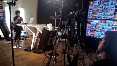 A news presenter and a cameraman work at the studio of Russia's only independent TV channel Dozhd in a living room in Moscow. Naira Davlashyan / AFP