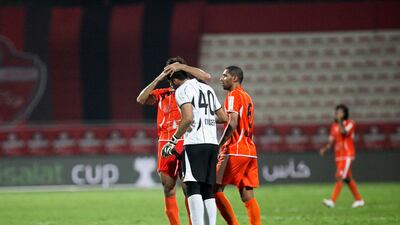 Ajman's players celebrate after two late goals hand them victory over Al Ahli in the Etisalat Cup tie. Lee Hoagland/The National