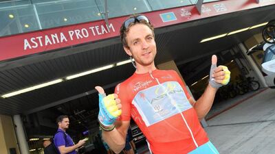 Tanel Kangert of Team Astana team wearing the red jersey poses for photographers prior the start of the stage. Luca Zennaro / EPA