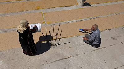 Palestinian Abed Al Lattif Karaje and his wife Nabeeha prepare traditional Malban sweets made from grape juice in Halhul near Hebron city, in the occupied West Bank.