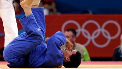 UAE athlete Humaid Al Derei lies on the mat during the elimination round match with Ahmed Award at London 2012.