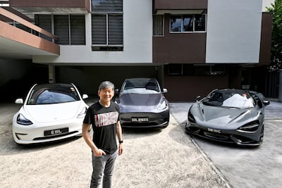 Eu Gene Goh with his three cars, a Tesla Model 3, a Tesla Model Y and a McLaren 765LT in Singapore. Reuters