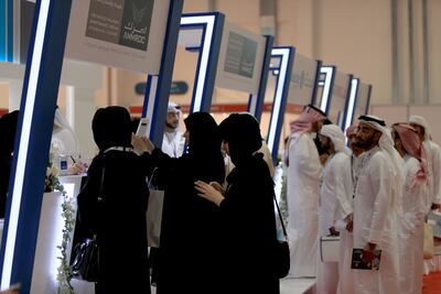Visitors to a Mubadala stall are briefed about jobs during an Emiratisation recruitment fair in Abu Dhabi. Ravindranath K / The National