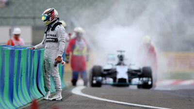 Lewis Hamilton walks away from his car after it caught fire during qualifying ahead of the Hungarian Formula One Grand Prix at Hungaroring on July 26, 2014 in Budapest, Hungary. Mark Thompson / Getty Images