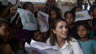 Jordan's Queen Rania sits with Rohingya children inside a temporary school run by the United Nations Children's Fund (UNICEF) during her visit to the Kutupalong refugee camp in Ukhia. Tauseef Mustafa / AFP