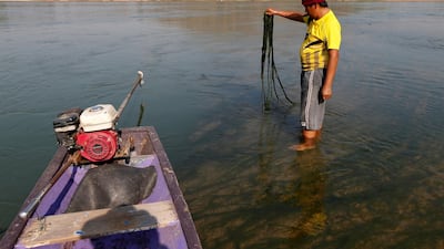 A fisherman shows the algae growing in Mekong river outside Loei, Thailand January 10, 2020. Soe Zeya Tun / Reuters