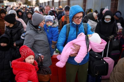 People fleeing the Russia invasion wait at the Shehyni border crossing. Reuters