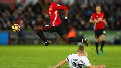 Stephen Kingsley of Swansea City attempts to tackle Paul Pogba of Manchester United. Michael Steele / Getty Images