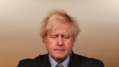 Britain's Prime Minister Boris Johnson closes his eyes as he leads a virtual press conference on the Covid-19 pandemic, from inside 10 Downing Street in central London. AP