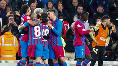Barcelona players celebrate with Pedri after he scores against Sevilla. AP