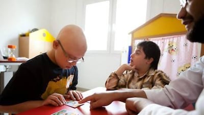 Mahmoud Omar Jarour, 13, left, and Abdullah Al Haj Nasser, 9, take part in an activity at the UAE Down Syndrome Association.