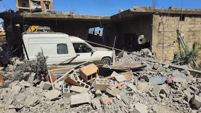 A vehicle trapped under the rubble of a destroyed building in the Lebanese town of Habboush. Reuters