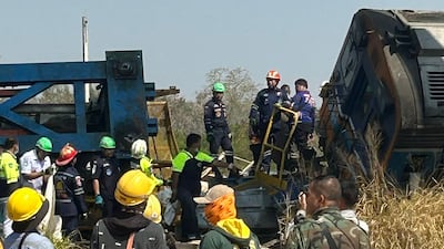 Rescue workers next to the wreckage. AFP
