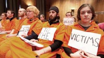 University students, wearing jumpsuits that symbolise rights abuse, attend a Senate committee hearing on a "truth commission".