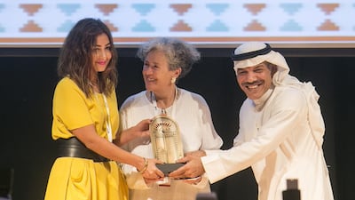 Shahad Ameen, left, is presented with her award for winning the short narrative in the Emirates Film Competition. Mona Al-Marzooqi/ The National