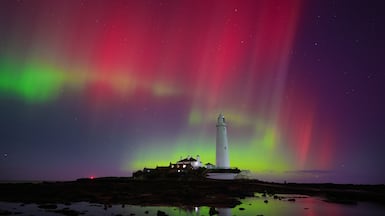 The northern lights over St Mary's Lighthouse in Whitley Bay on the North East coast of England. PA