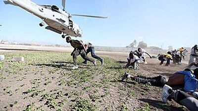 Doctors and nurses are warning of a shortage of staff and supplies to treat the wounded in Haiti. Above, Haitians rush to pick up water.