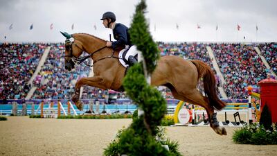 Australia's Christopher Burton and his horse HP Leilani, clear a jump in the equestrian eventing individual show jumping. David Goldman / AP Photo