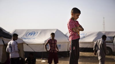 A boy, who fled from the violence in Mosul, stands near tents in a camp for internally displaced people on the outskirts of Erbil, in Iraq's Kurdish region, on June 14. Jacob Russell / Reuters