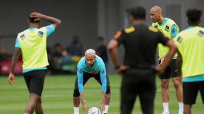 Brazil's Neymar, second left, warms up with teammates at the National Stadium in Tokyo. AP