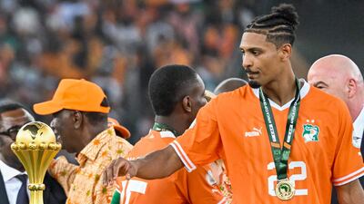 Sebastien Haller, who scored an 81st-minute winner to clinch a 2-1 victory over Nigeria in the Afcon final, looks at the Africa Cup of Nations trophy during the presentation ceremony. AFP