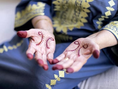 A woman in Dubai with her hands decorated with henna. Reem Mohammed / The National