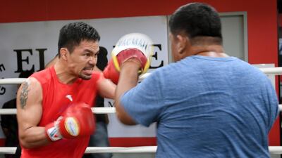 Manny Pacquiao, left, sparring with his childhood friend and long-time assistant trainer Buboy Fernandez during a training session at a gym in Manila, ahead of his world welterweight boxing championship bout against Argentina's Lucas Matthysse in July. Ted Aljibe / AFP