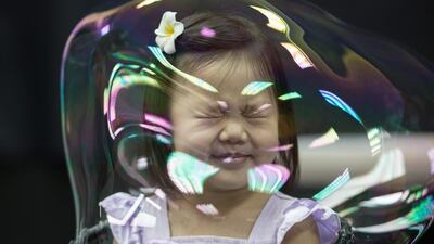 A girl reacts as she stands in a soap bubble during Spanish artist Pep Bou’s Bubble Magic show in Hong Kong. The world-renowned bubble artist is in Hong Kong to perform eight shows. EPA