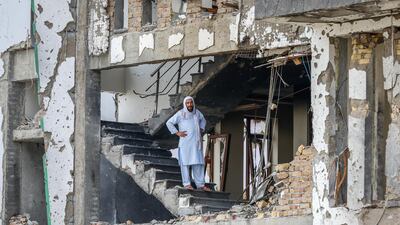 A man stands on the middle of a ruined residential building in Kabul, Afghanistan, after a complex suicide attack followed by a fire fight against the office of Afghan Green Trend. At least 20 people were killed and 50 others wounded in the incident. EPA