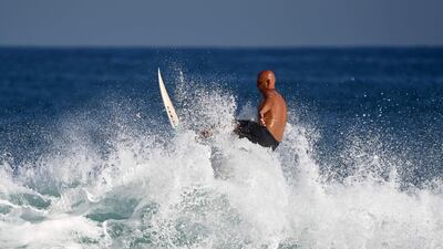 A surfer rides a wave at Zurriola Beach in San Sebastian, Spain. AFP