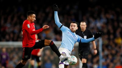 Manchester United's Jesse Lingard battles with Manchester City's Nicolas Otamendi. Reuters