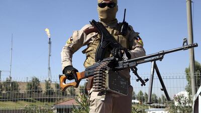 A member of the Kurdish security forces takes up his position guarding an oil refinery on the outskirts of Mosul on June 22, 2014. Azad Lashkari / Reuters