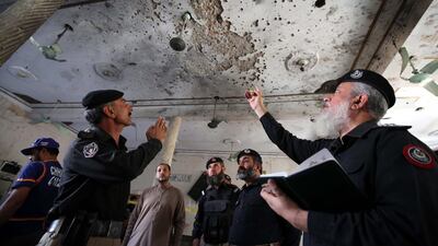 epa08776793 Pakistani security officials inspect the scene of an explosion at an Islamic seminary in Peshawar, Pakistan. EPA