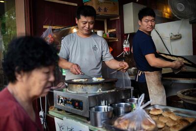 A vendor fries eggs at a restaurant in Beijing. Chinese eat around 1 billion eggs a year. AFP