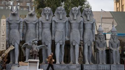 A man walks in front of pharaonic statues that are used in Cairo opera house shows, in Cairo, Egypt. EPA