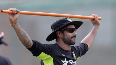 India cricketer Shikhar Dhawan stretches during a team training session on Monday before their first Test of the summer starts on Wednesday against Bangladesh. AM Ahad / AP