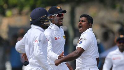 Sri Lanka's Rangana Herath, right, celebrates during Day 2 of the second Test against Australia in Galle. Eranga Jayawardena / AP Photo / August 5, 2016