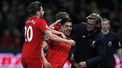 Jurgen Klopp celebrates with Emre Can, centre, after the midfielder's spectacular and decisive goal against Watford. Adrian Dennis / AFP