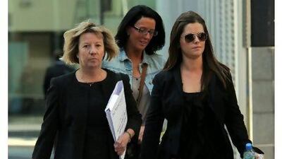 Jennifer Green, right, arrives at Manchester Magistrates Court yesterday. She is the girlfriend of the alleged ringleader of the blackmail scheme. Paul Ellis / AFP