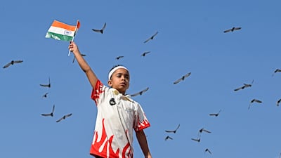 A Kashmiri child waves an Indian national flag during a high-altitude bike expedition by the Central Reserve Police Force, in Srinagar. AFP