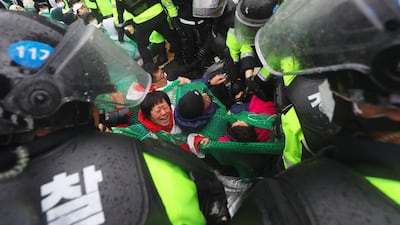 Riot police remove South Korean protesters opposing the deployment if a US THAAD system from blocking the road in Seongju. Yonhap / AFP Photo
