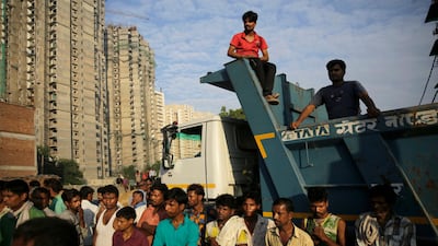 Residents watch rescuers work at the site of a building collapsed in Shahberi village. AP Photo
