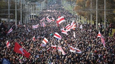 People with old Belarusian national flags march during an opposition rally to protest the official presidential election results in Minsk, Belarus. AP Photo