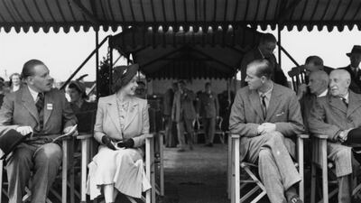 Queen Elizabeth talking to Prince Philip (second right), the Duke of Edinburgh, at the Royal Horse Show at Windsor, England. Getty Images