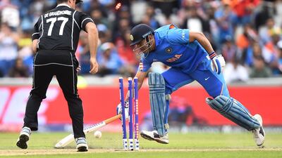 MS Dhoni of India is run out by Martin Guptill's direct hit. Getty