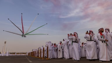 Tribesman watch the display by Al Fursan aerobatic team over Al Wathba. Antonie Robertson / The National
