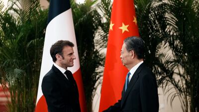 Mr Macron with the head of China's National People’s Congress, Zhao Leji, before a meeting at the Great Hall of the People in Beijing. AP